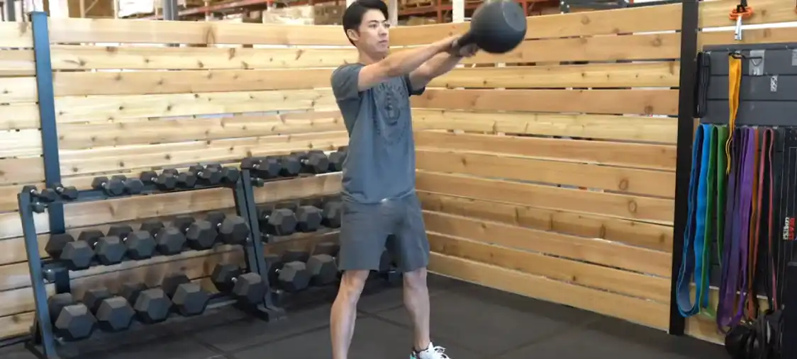 A man is doing kettlebell swing using Bells Of Steel Adjustable Kettlebell.